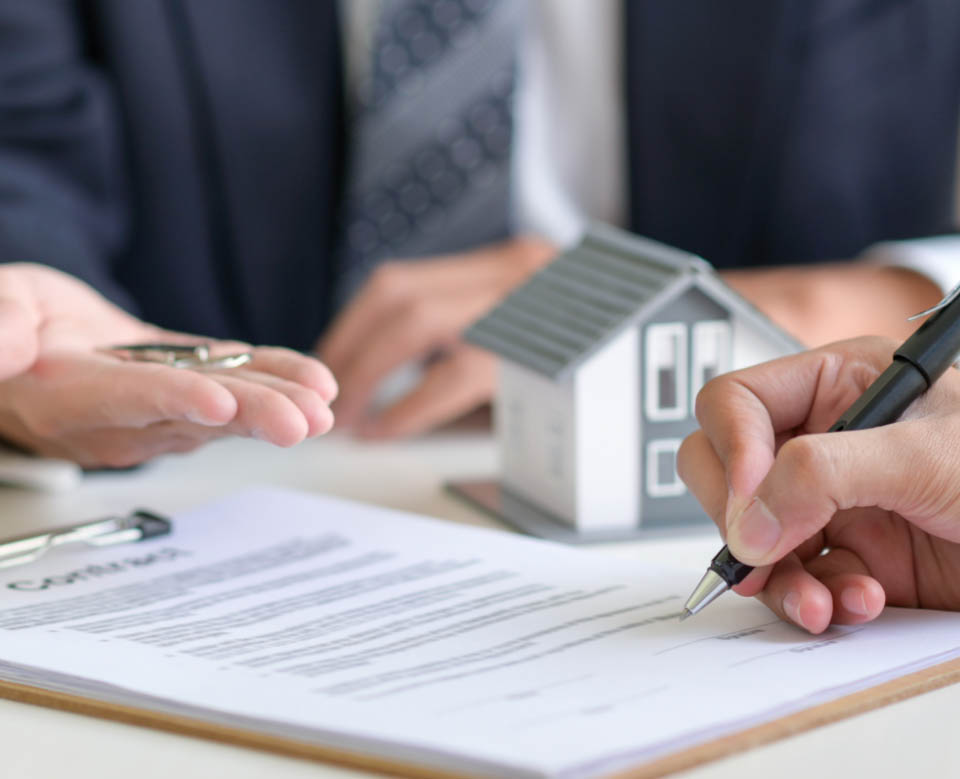 Signing a loan for a home purchase.